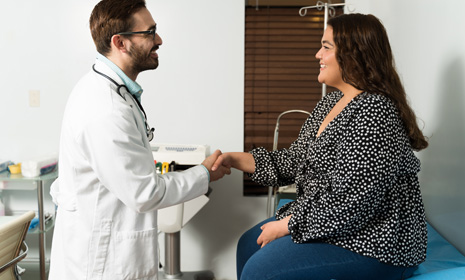 Paciente y médico estrechando manos en consulta